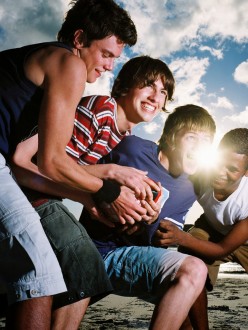 Group of Young Men Wrestling Playfully — Image by © Royalty-Free/Corbis